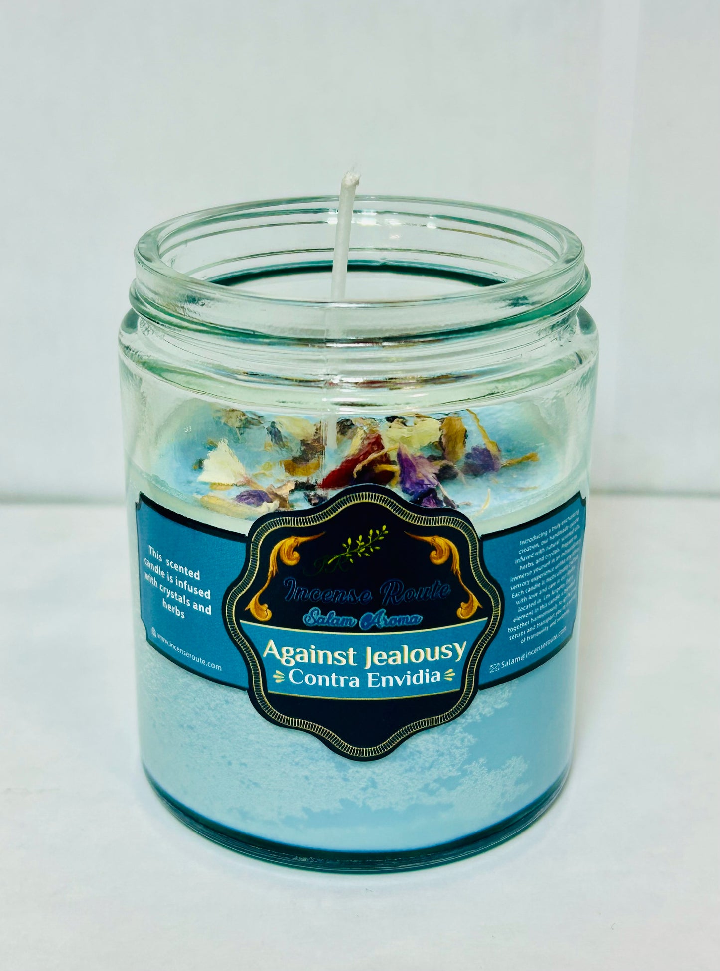 Handmade scented blue candle with herbs and crystals